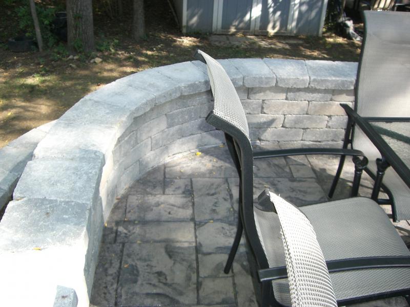 Curved retaining and seating walls with raised stamped concrete patio