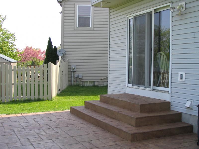 Square concrete wedding cake steps with grand ashler slate stamped patio