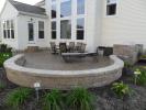 Stamped concrete patio with seating wall, column and grill enclosure.